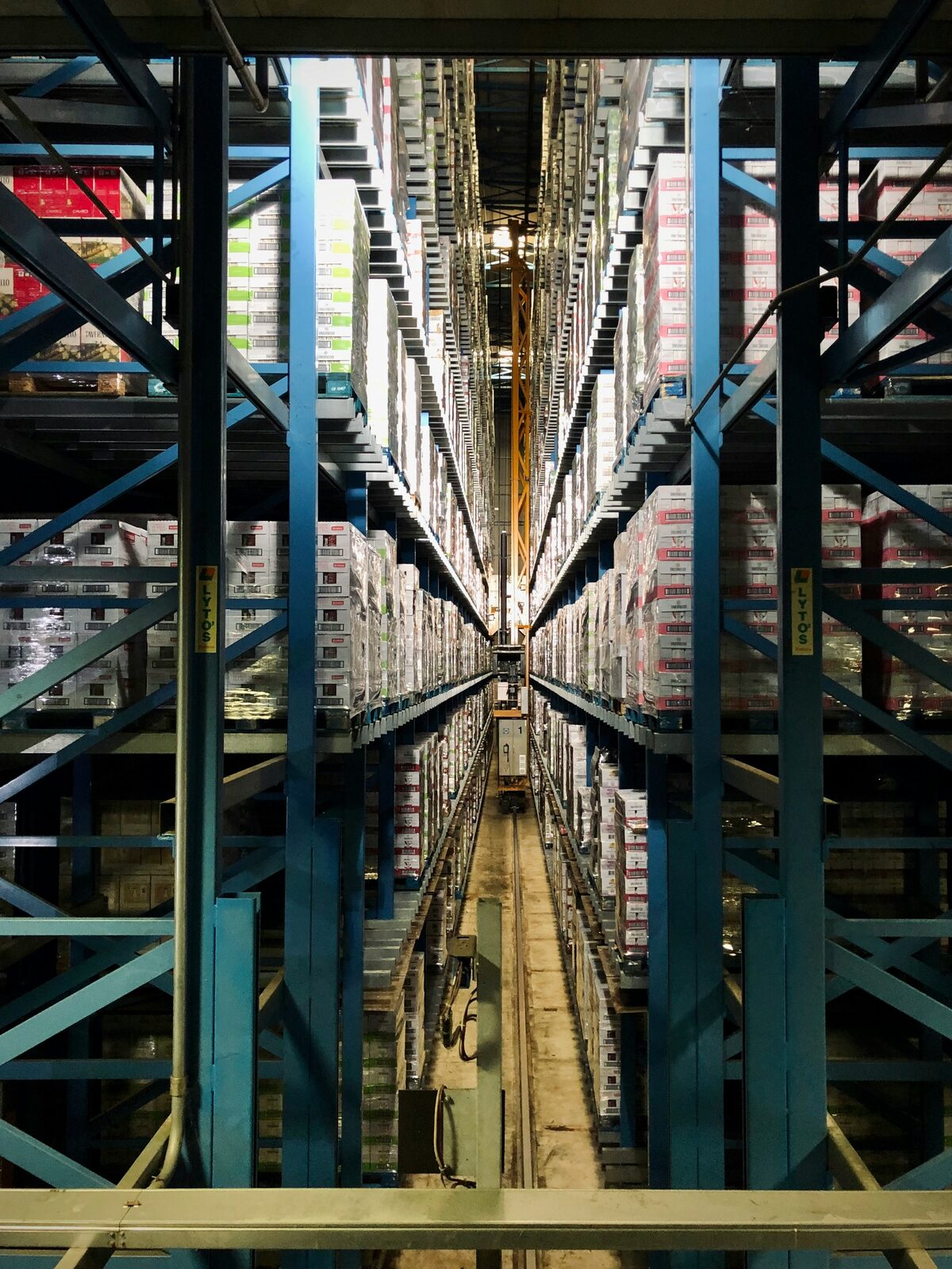 High-bay warehouse aisle lined with pallet racking